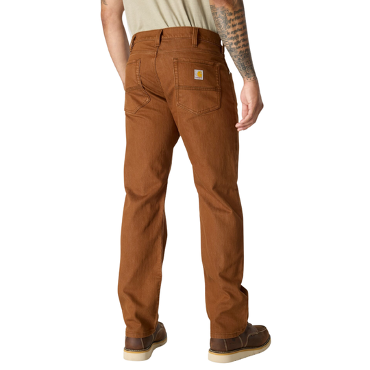A man shown from the back wearing brown Carhartt work pants, a light beige t-shirt, and brown shoes, against a plain white background.