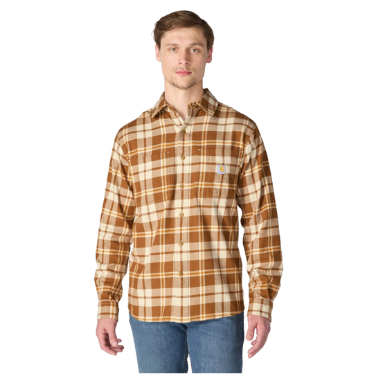 A man wearing a Carhartt long-sleeve plaid button-up shirt in brown and beige, paired with blue jeans, against a plain white background.