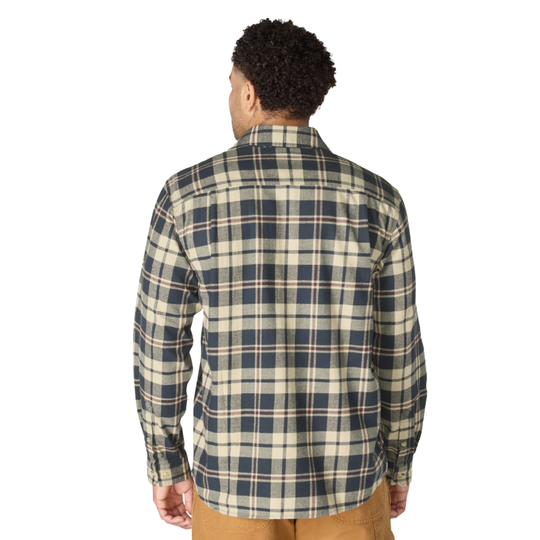 A man viewed from behind wearing a long-sleeve plaid button-up shirt in navy blue and beige, paired with tan pants, against a plain white background.
