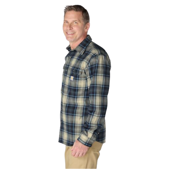 A man wearing a long-sleeve plaid button-up shirt in navy, beige, and green, paired with khaki pants, shown from a side profile against a white background.