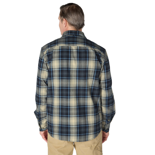 A man viewed from the back wearing a long-sleeve plaid button-up shirt in navy blue, beige, and white, paired with khaki pants, against a plain white background.