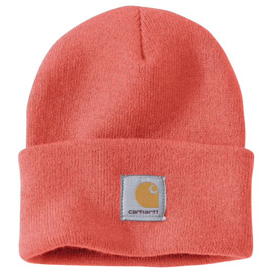 A coral pink knit beanie hat with a folded cuff and a square Carhartt logo patch on the front, shown against a plain white background.