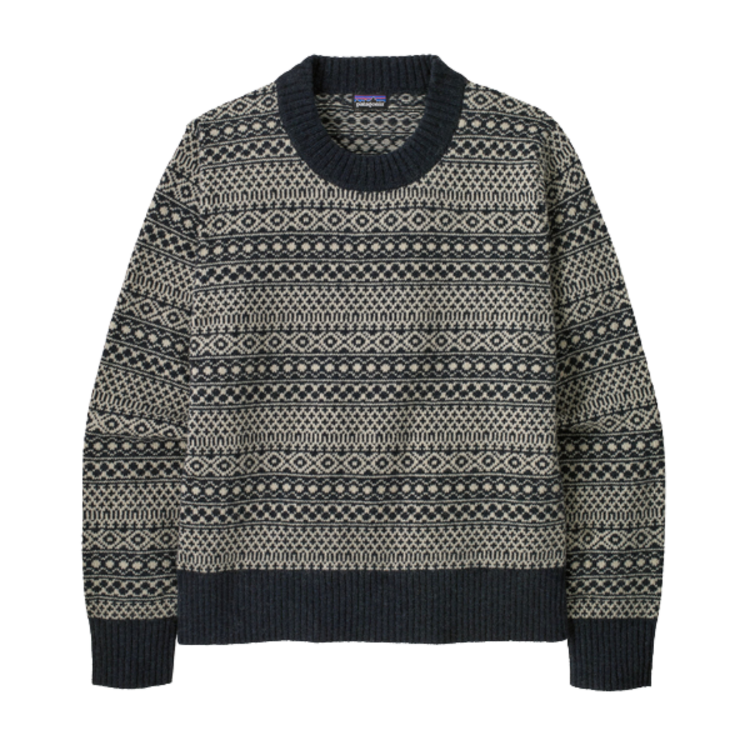 A long-sleeve crewneck knit sweater with a dark navy ribbed collar, cuffs, and hem, featuring a cream and navy Fair Isle geometric pattern across the body.