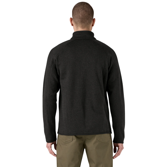 A man viewed from the back wearing a dark charcoal heathered quarter-zip fleece pullover and olive green pants, set against a plain white background.