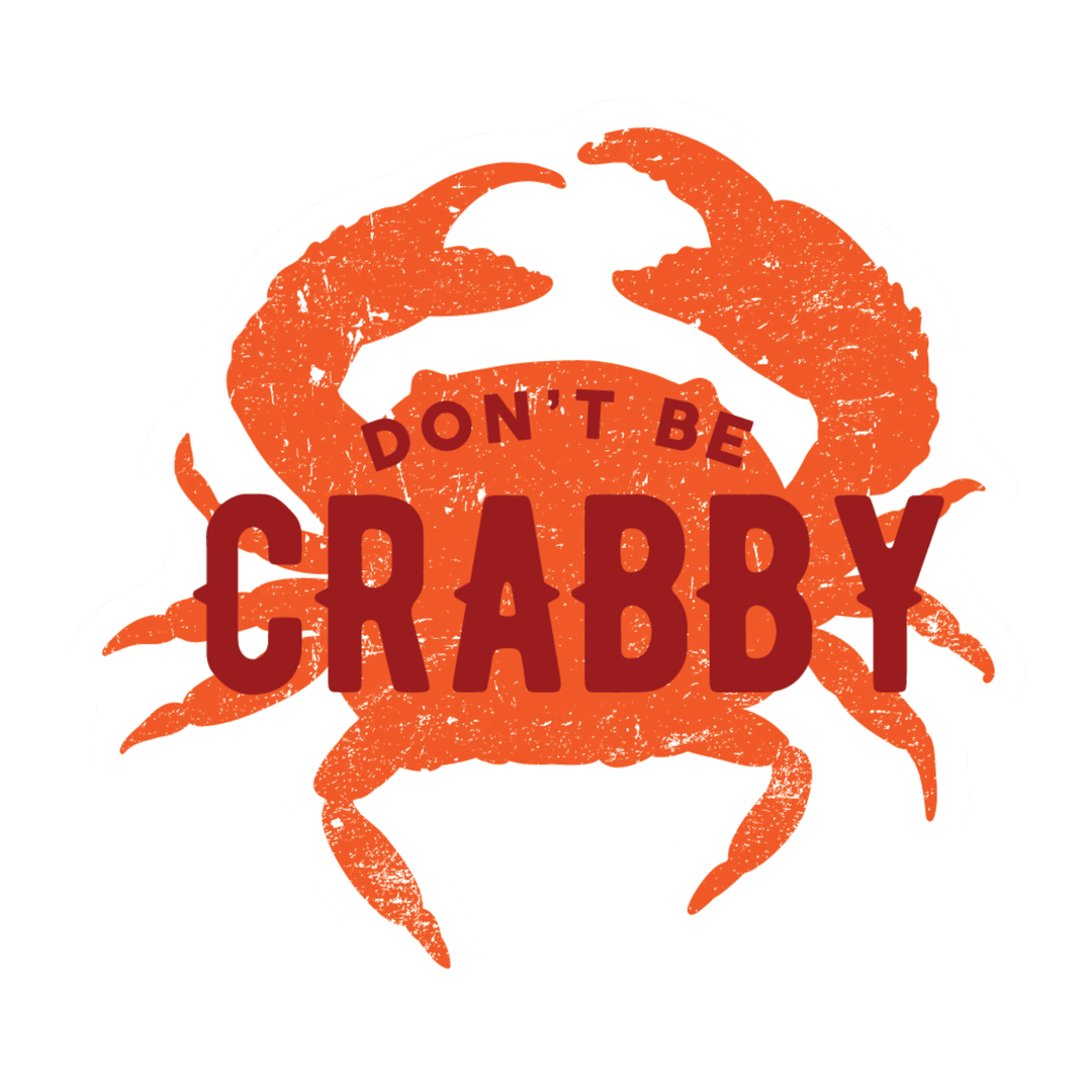 A graphic design featuring an orange crab silhouette with distressed texture and the phrase 'DON'T BE CRABBY' in dark red text across the center, set against a plain white background.