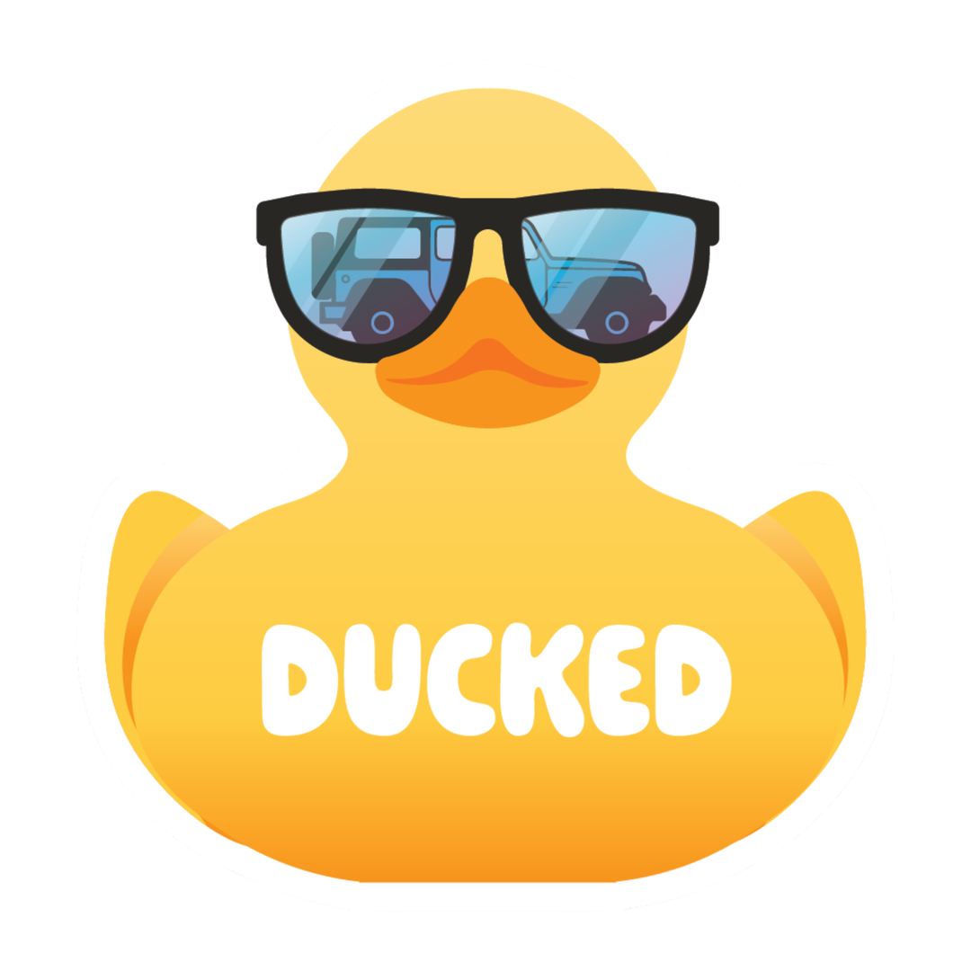 A yellow rubber duck wearing black sunglasses with blue-tinted lenses and the word 'DUCKED' in white across the front, on a plain white background.