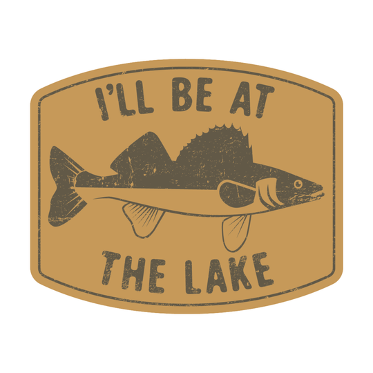 A rectangular sticker or patch with rounded corners featuring a distressed fish illustration and the text 'I'LL BE AT THE LAKE' on a tan background.