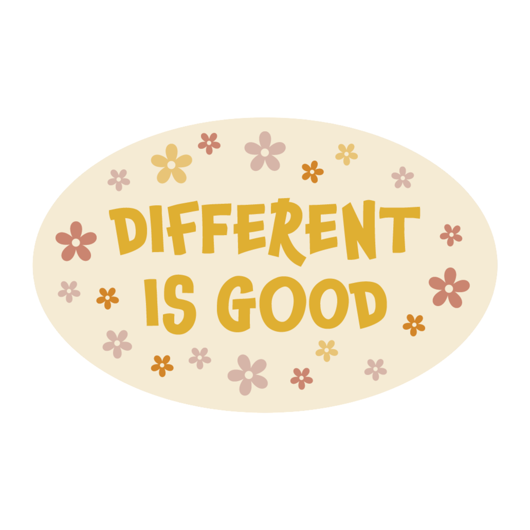 An oval sticker or decal with the phrase 'DIFFERENT IS GOOD' in a warm mustard-yellow hand-drawn font, surrounded by small pastel flowers in pink, yellow, and orange on a cream background.