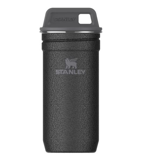 A black textured Stanley travel tumbler with a dark gray lid and a silver Stanley logo on the front, set against a plain white background.