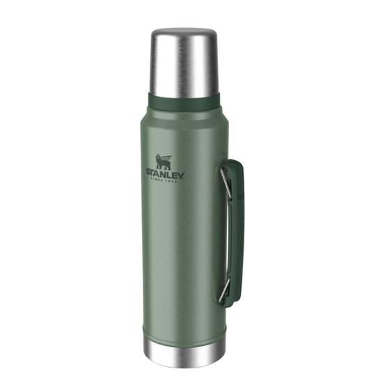 A Stanley vacuum-insulated stainless steel water bottle in sage green with a matching green carrying loop and silver metal accents, shown on a plain white background.
