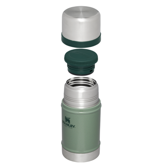 A Stanley vacuum-insulated bottle shown disassembled with its lid and cap removed, revealing the stainless steel interior. The bottle body is sage green with the Stanley logo, and the lid components are silver and dark green, set against a plain white background.