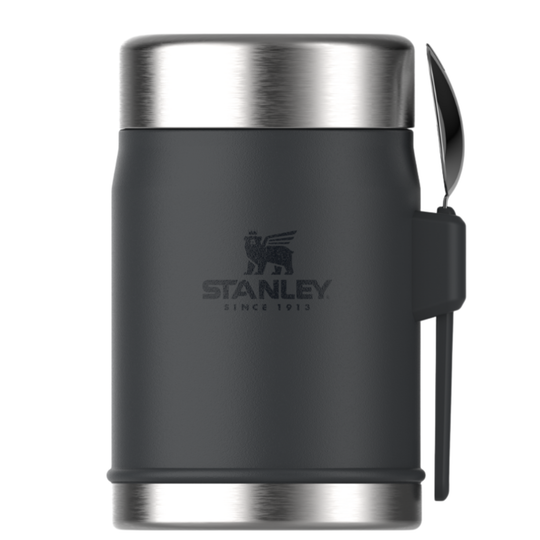 Stanley insulated container in dark gray with a stainless steel lid and base, featuring a black silicone strap with a spoon attached, on a white background.
