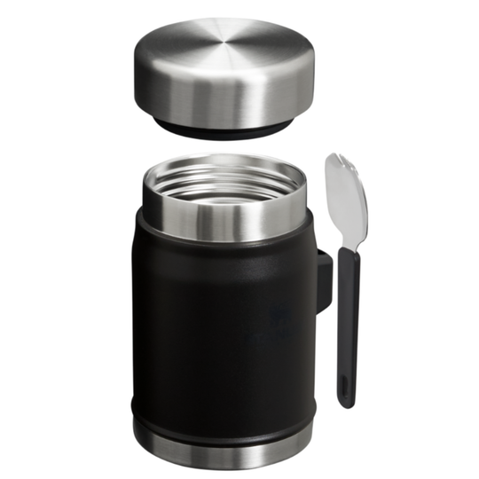 A black insulated travel mug with a matching stainless steel lid shown disassembled above the container, alongside a small spoon on a plain white background.