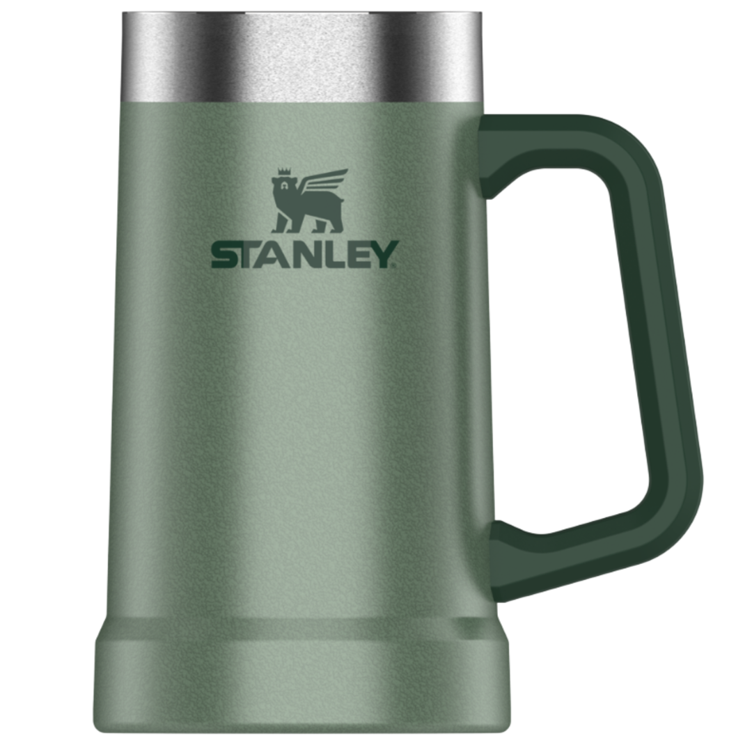 Stanley insulated mug in a matte sage green color with a dark green handle and a brushed silver stainless steel rim, featuring the Stanley logo on the front.