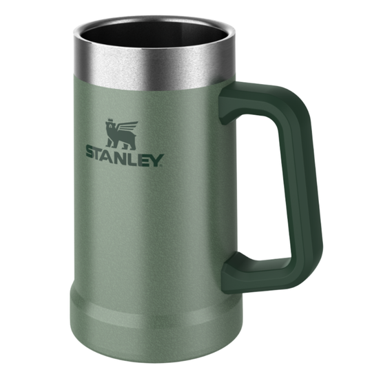 A Stanley insulated metal mug in sage green with a dark green handle and a brushed silver stainless steel rim, shown on a plain white background.