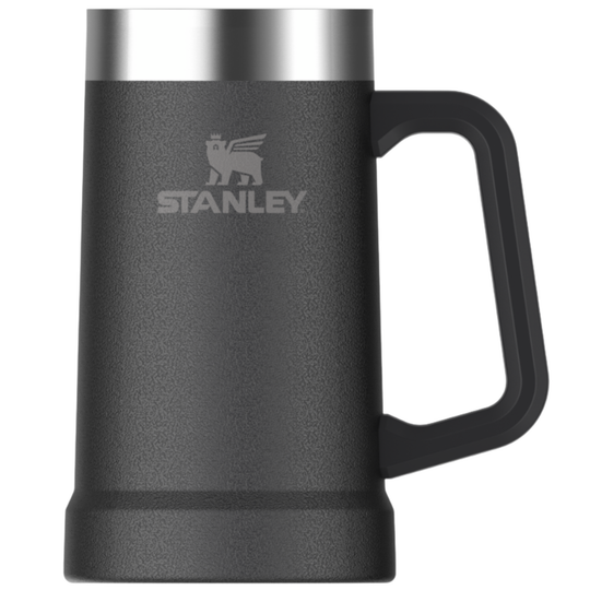 A Stanley insulated beer mug in matte black with a brushed silver stainless steel rim and a black handle, shown on a plain white background.