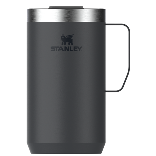 A dark gray Stanley travel mug with a stainless steel lid, black handle, and black Stanley logo on the front, set against a plain white background.