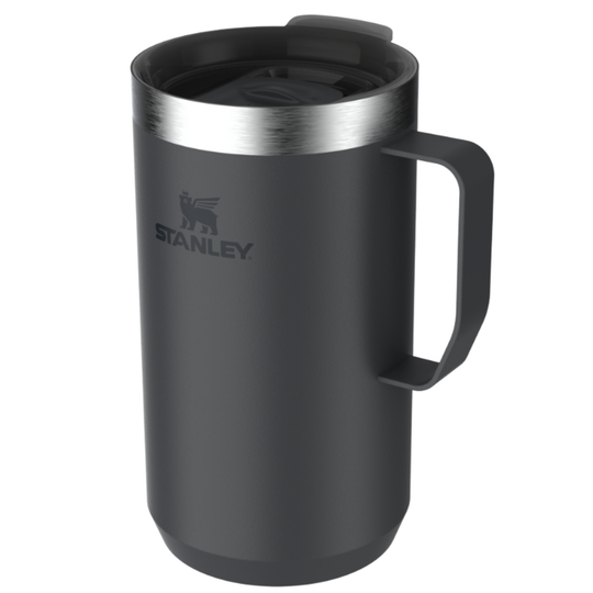 Stanley travel mug in matte dark gray with a stainless steel rim, black handle, and matching lid, shown on a plain white background.