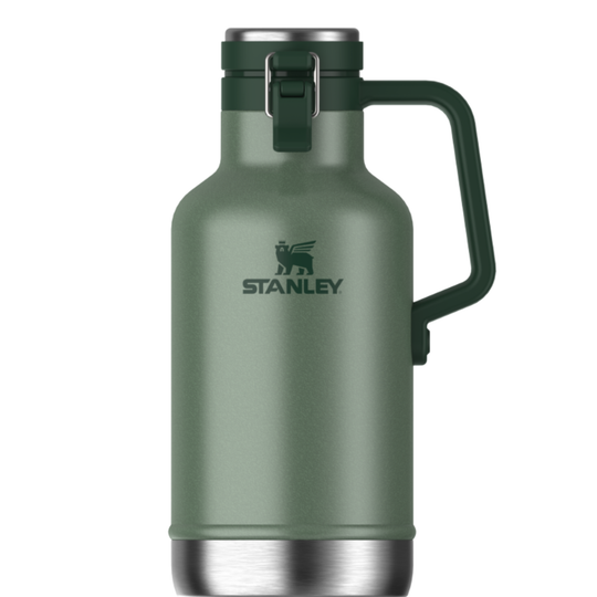 A Stanley growler bottle in matte sage green with a dark green handle and lid, featuring a stainless steel base and a silver metal logo on a white background.