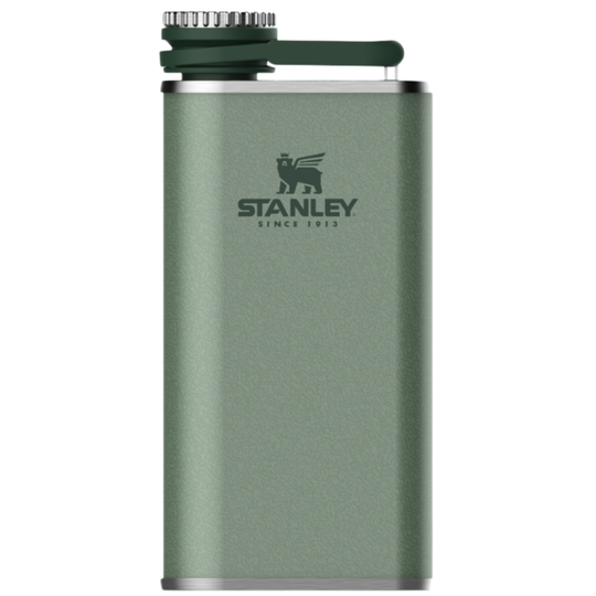 A green Stanley insulated flask with a silver metal body, dark green lid and handle, and the Stanley logo printed on the front, shown against a plain white background.