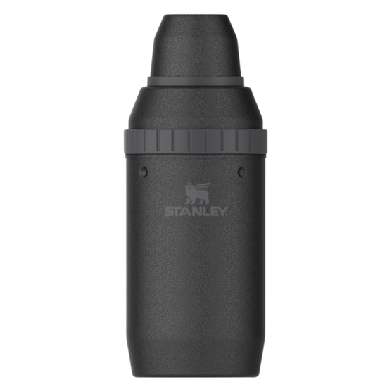 A dark gray metallic Stanley bottle with a textured finish, featuring the Stanley logo on the front, set against a plain white background.