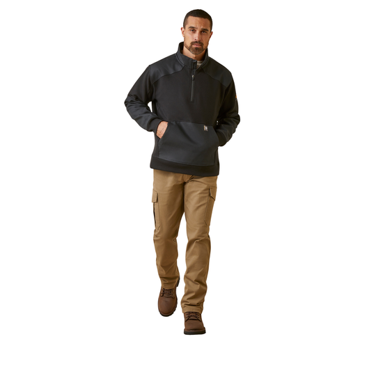 A man modeling a black and dark gray quarter-zip pullover jacket paired with tan cargo pants and brown boots, set against a plain white background.