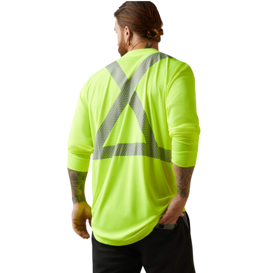 A man viewed from the back wearing a high-visibility neon yellow long-sleeve shirt with reflective gray diagonal stripes across the back, paired with black pants, against a plain white background.