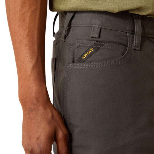 Close-up of gray Ariat pants with a visible brand logo on a white background