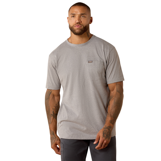 A man wearing a light gray heather crewneck pocket t-shirt with a small Patagonia logo on the chest, paired with dark gray pants, photographed against a solid white background.
