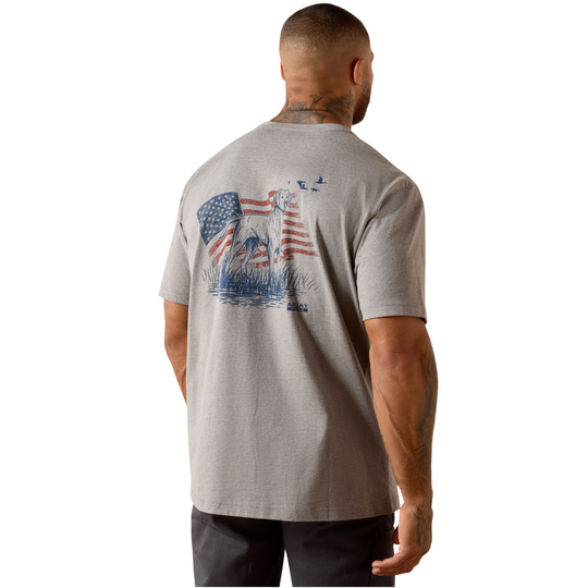 A man viewed from the back wearing a heather gray t-shirt with a large patriotic graphic on the back featuring an American flag, bald eagle, and blue birds.