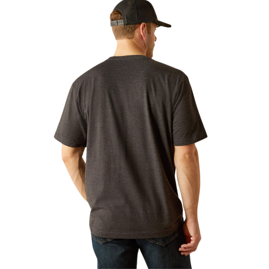 A man viewed from the back wearing a dark charcoal heather short-sleeve t-shirt, blue jeans, and a black trucker hat against a plain white background.