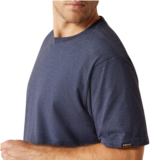 Man wearing a navy blue t-shirt with a visible brand logo on a white background