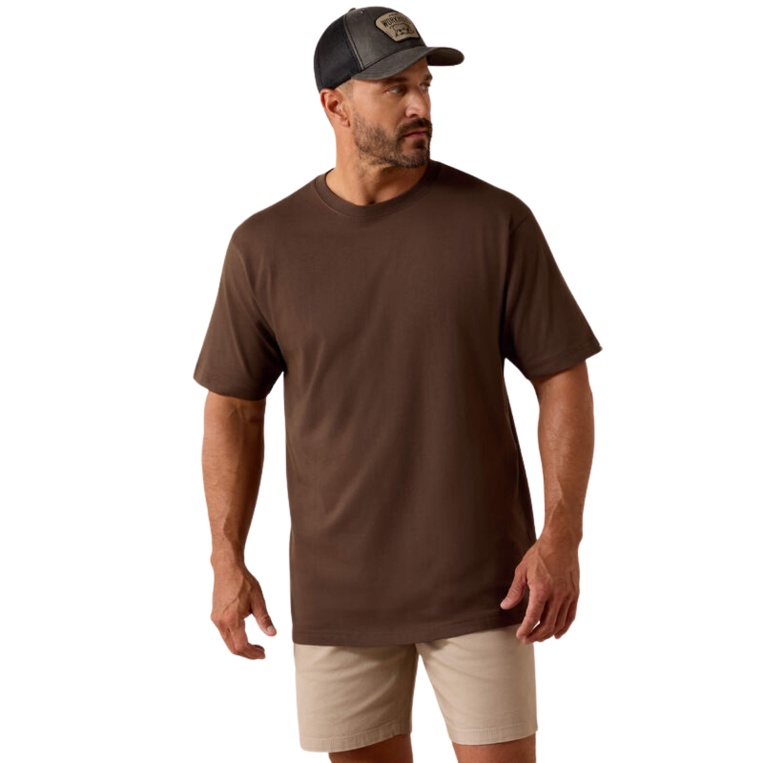 A man wearing a brown short-sleeve crewneck t-shirt, beige shorts, and a dark gray baseball cap, shown against a plain white background.