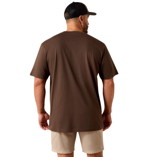 A man viewed from the back wearing a brown short-sleeve crewneck t-shirt, beige shorts, and a black baseball cap, set against a plain white background.