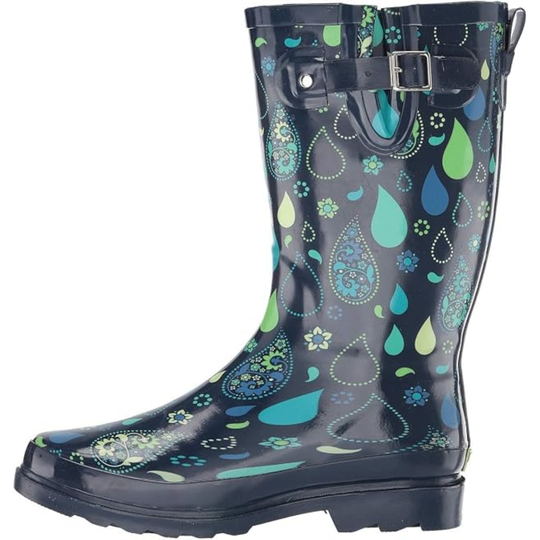 A single glossy rain boot with a dark navy base and a vibrant paisley and floral pattern in shades of teal, green, and blue. It features a black strap with a silver buckle around the upper shaft, set against a plain white background.