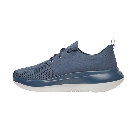 A single casual sneaker in slate blue, featuring a textured mesh upper, matching blue laces, a thick sculpted blue midsole, and a contrasting white outsole, shown from a side profile on a white background.