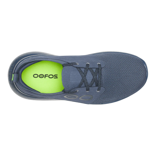 A single Oefos athletic shoe shown from a top-down view, featuring a dark slate blue mesh upper, matching dark laces, and a bright neon green insole with the brand name 'OEFOS' printed in black.