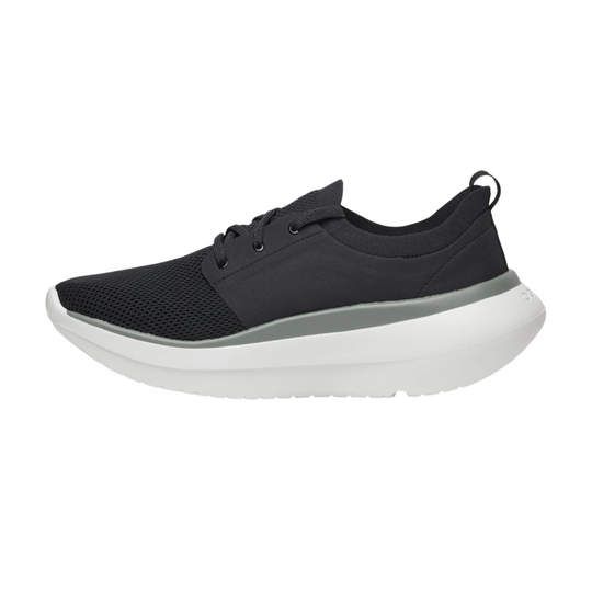 A black low-top athletic sneaker with a thick white sole and a subtle gray midsole accent, shown in a side profile on a white background.