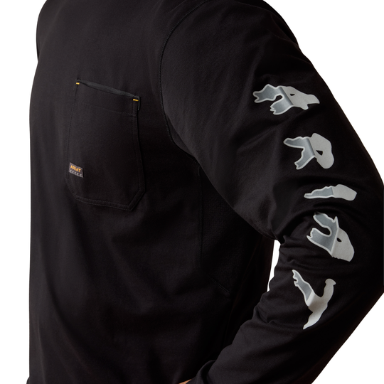 Close-up of a black long-sleeve work shirt with a chest pocket and a large gray graphic logo printed down the right sleeve, shown on a model against a white background.