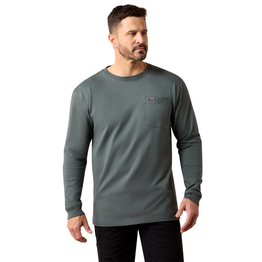 A man wearing a dark gray long-sleeve crewneck shirt with a chest pocket, paired with black pants, photographed against a solid white background.