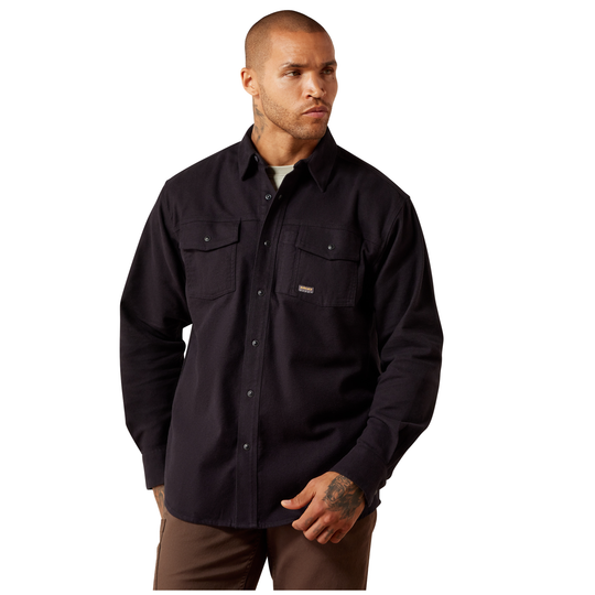 A man wearing a dark navy long-sleeve button-up shirt with two chest pockets, photographed against a plain white background.