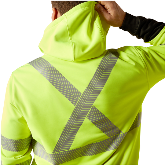A person viewed from the back wearing a high-visibility neon yellow-green hooded jacket with reflective diagonal and crisscross gray stripes, against a plain white background.
