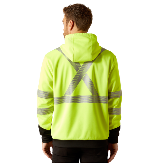 A man viewed from the back wearing a high-visibility neon yellow hooded jacket with reflective gray diagonal stripes forming an X across the back and horizontal stripes on the sleeves.