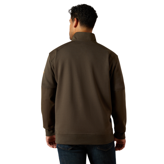 A man viewed from the back wearing a dark brown quarter-zip pullover jacket and blue jeans, set against a plain white background.