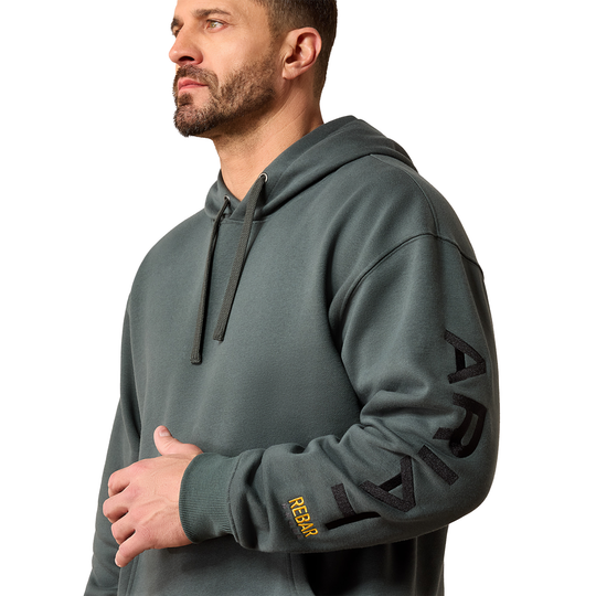 Man wearing a gray hoodie with 'Reebok' branding on a white background
