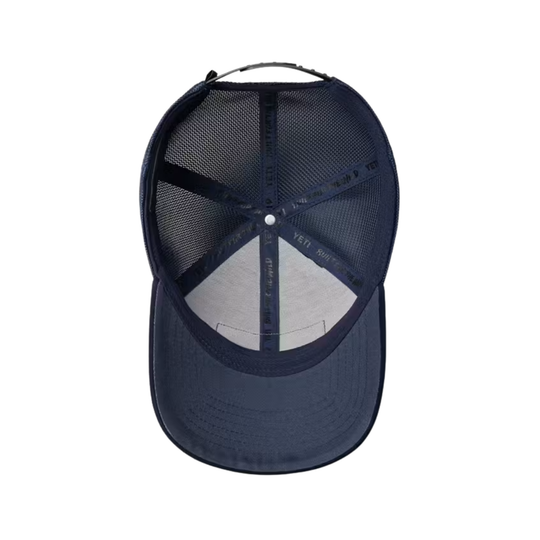 A navy blue trucker-style baseball cap viewed from the back, featuring a dark navy mesh back and a curved brim, isolated on a white background.