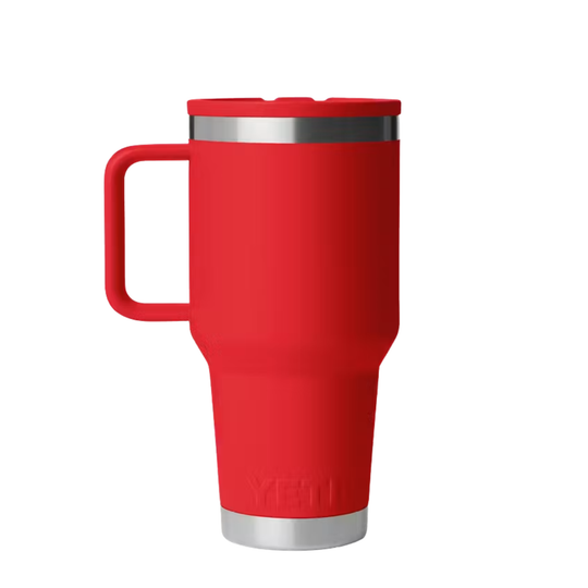 A red YETI travel mug with a matching red handle and lid, featuring a stainless steel rim and base, shown on a plain white background.