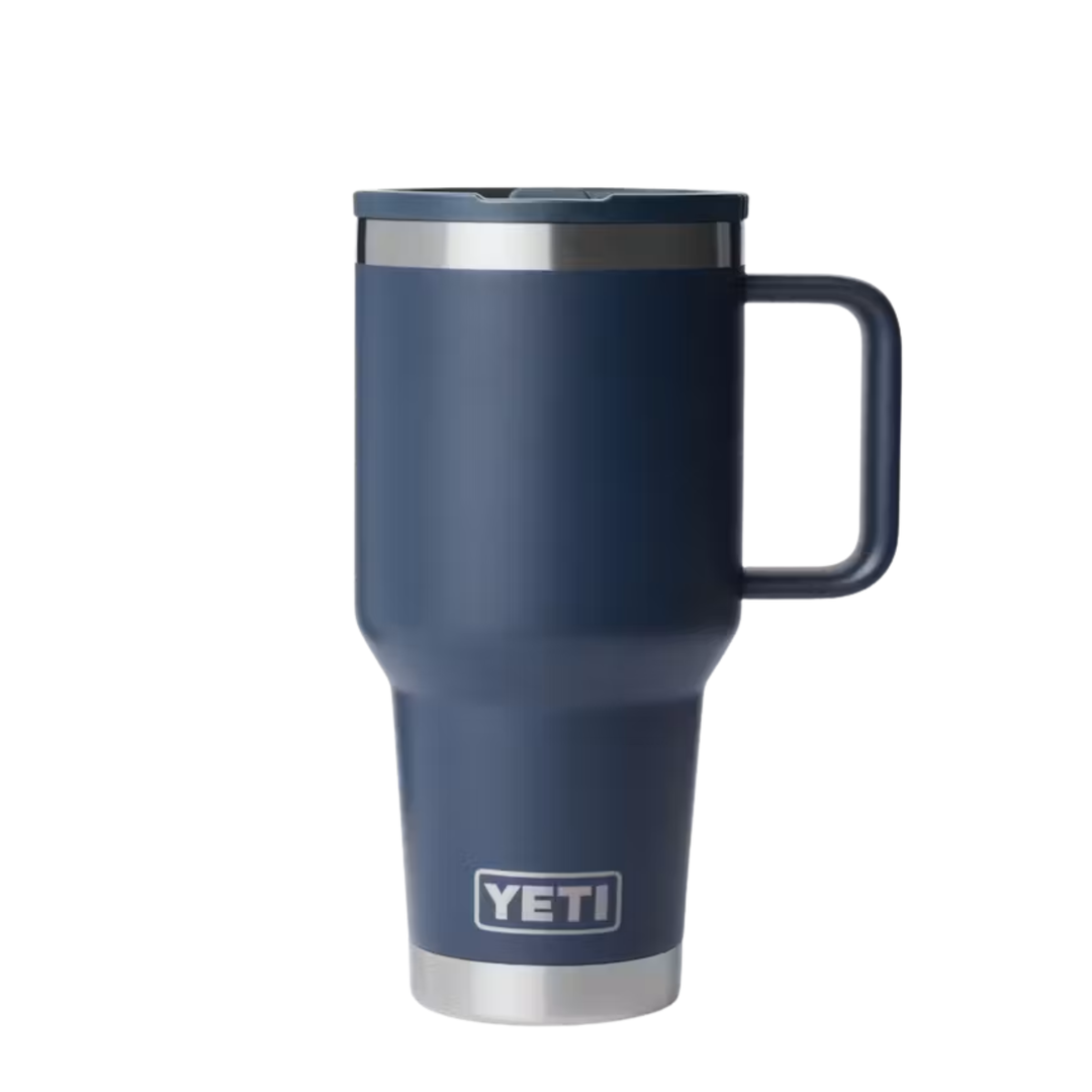 A YETI travel mug in matte navy blue with a stainless steel rim, a matching navy lid, and a sturdy handle, shown on a plain white background.