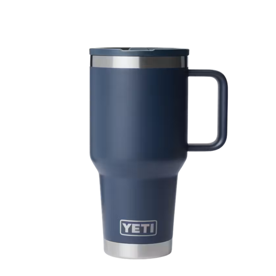 A YETI travel mug in matte navy blue with a stainless steel rim, a matching navy lid, and a sturdy handle, shown on a plain white background.