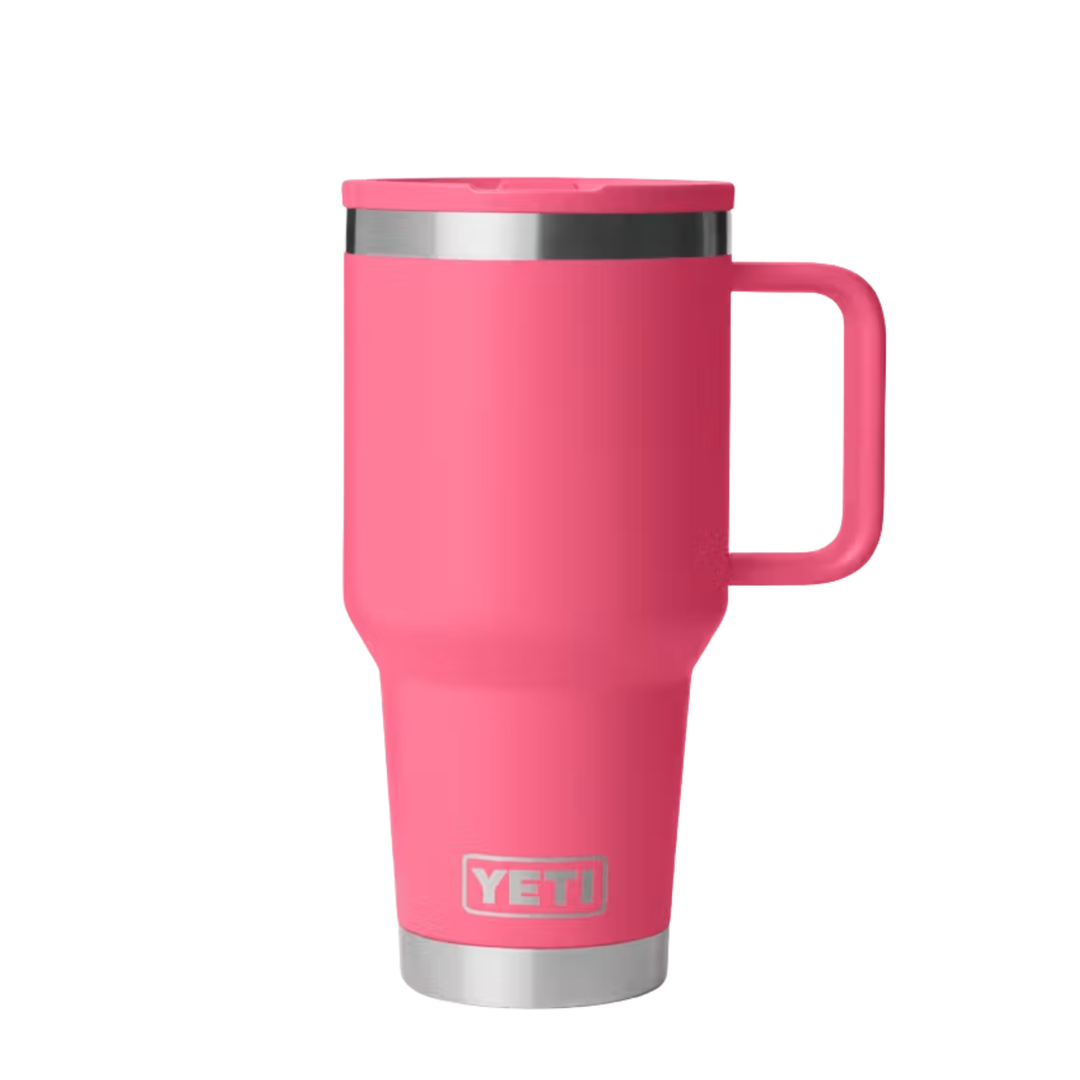 A pink YETI travel mug with a stainless steel rim and base, featuring a matching pink lid and handle, shown on a plain white background.